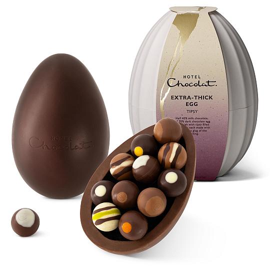 Hotel Chocolat Tipsy Chocolate Truffles Extra Thick Easter Egg, Two chocolate shells with the chocolates in display.